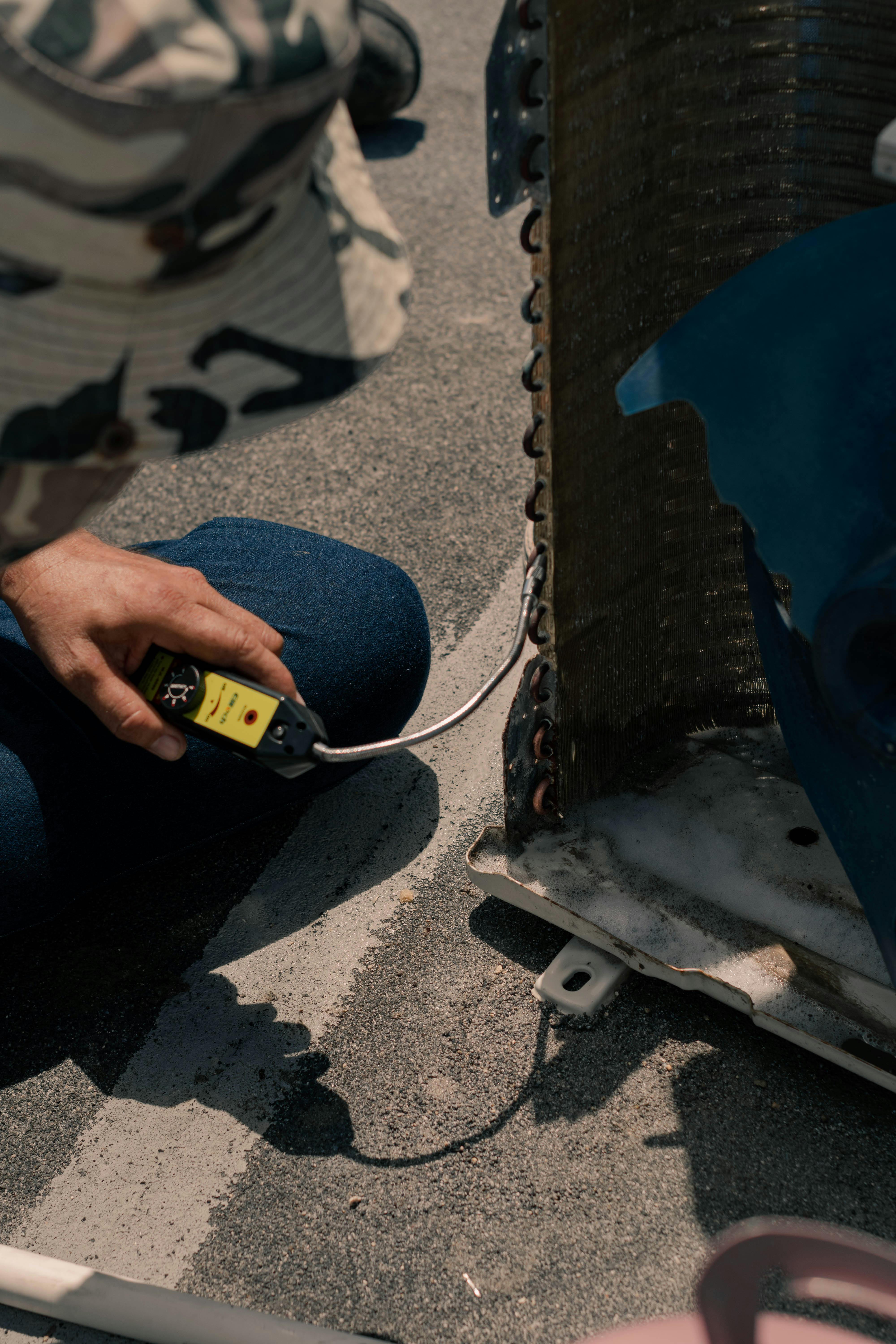 HVAC technician using diagnostic equipment for heating and cooling system repair in Nixa MO